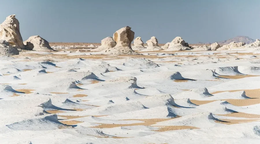 The iconic, wind-sculpted white chalk rock formations resembling mushrooms and icebergs in the White Desert, near Farafra Oasis