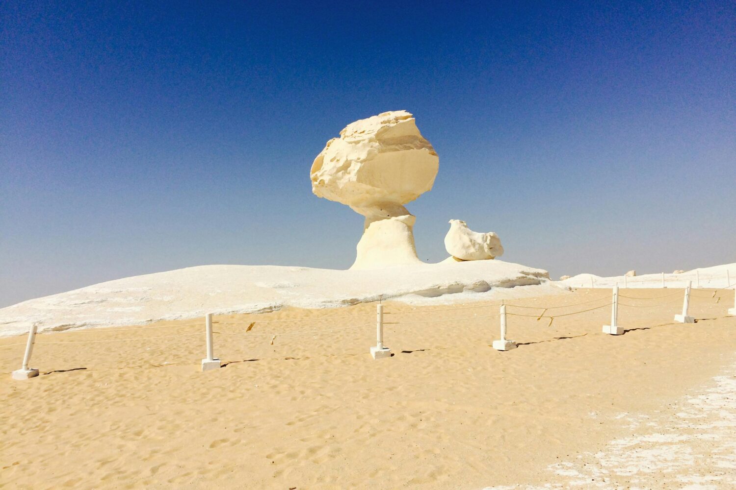 panoramic view of the distinctive eroded chalk pillars and 'mushroom' formations unique to the Bahariya White Desert